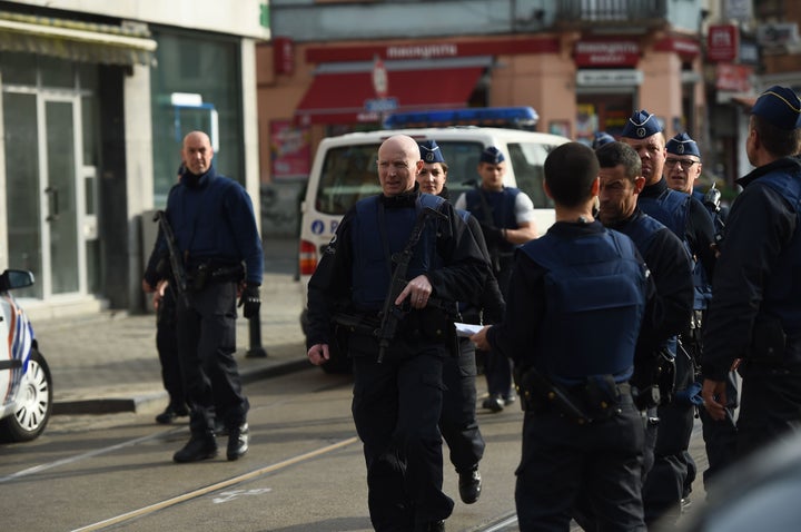 Police officers walk in the street near the site of a shooting on Dries-Driesstraat at Forest-Vorst in Brussels on March 15, 2016