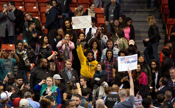 Protesters and Donald Trump supporters confront each other during a Trump rally at the UIC Pavilion in Chicago on March 11, 2016. Recent polls say the clashes did little to change most Republicans' opinions of Trump.