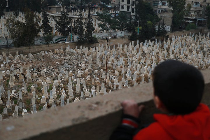 A recent report by a coalition of aid and human rights organizations showed that 2015 might have been the worst year since the beginning of the Syrian war in 2011. A boy looks over a cemetery in Arbeen, Syria.