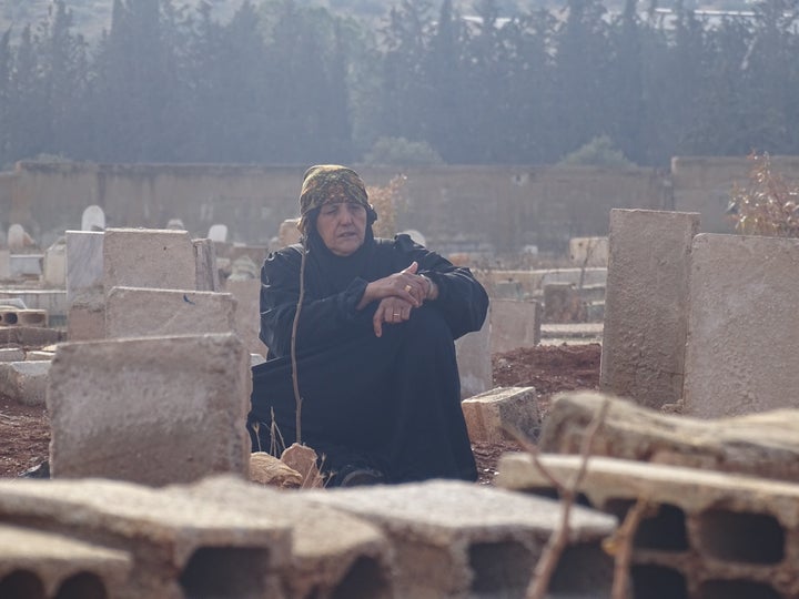 A woman visits a cemetery in Daraa, Syria, after her son was killed by regime forces. Some 470,000 people have died