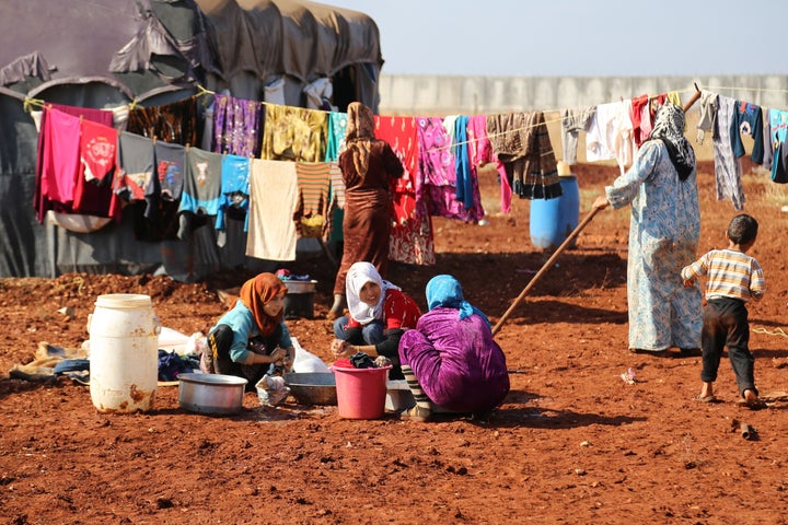 Women and children wash their clothes at a camp in Idlib, Syria. Almost 1 million people were forced to flee their homes in 2015 as a result of airstrikes and bombs.