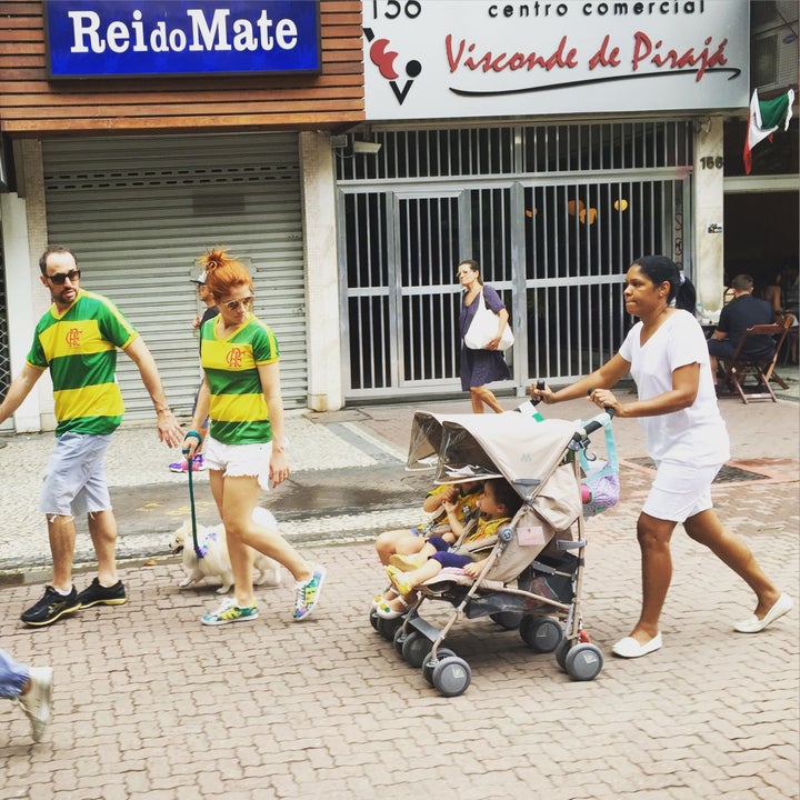 This photo of Claudio and Carolina Maia Pracownik marching in Brazil's recent anti-government protests, while their nanny, Maria Angélica Lima, trails behind with their children, has gone viral on social media.