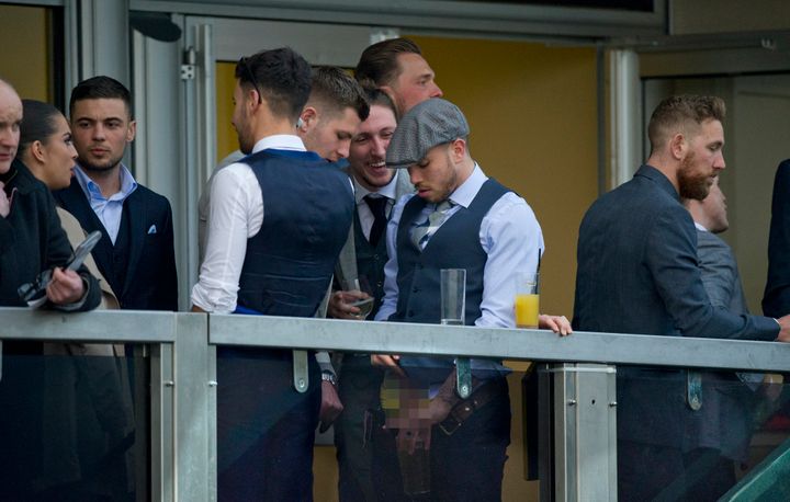 Samir Carruthers, wearing the grey flap cap, was shown appearing to urinate in a glass
