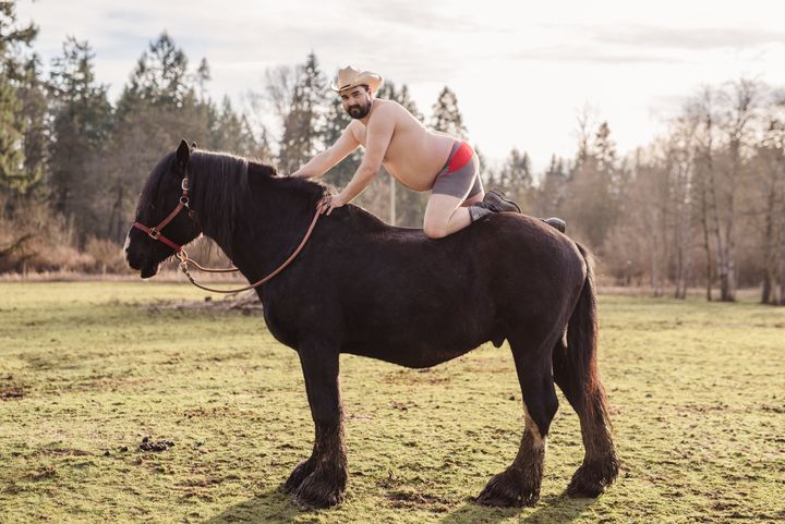 Patrick poses on a horse at his farm for his "dudeoir" photoshoot.