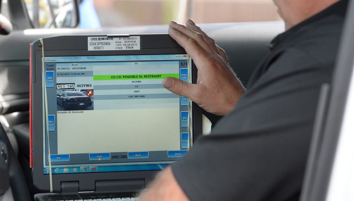 A Denver police officer shows off technology that scans license plates to see if cars might have been involved in crimes or if the driver the car is registered to might have be driving illegally. (Photo By Brent Lewis/The Denver Post via Getty Images)