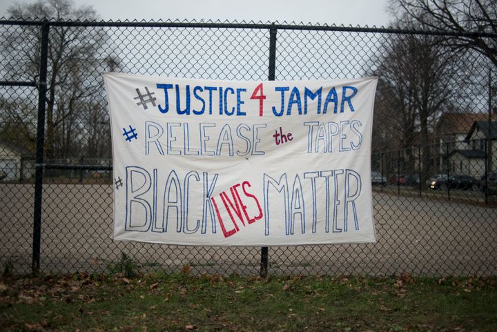 MINNEAPOLIS, MN - NOVEMBER 20: A sign demanding the release of video footage of the killing of Jamar Clark hangs on a fence at a candlelight vigil held for Clark outside the 4th police precinct November 20, 2015 in Minneapolis, Minnesota. (Photo by Stephen Maturen/Getty Images)