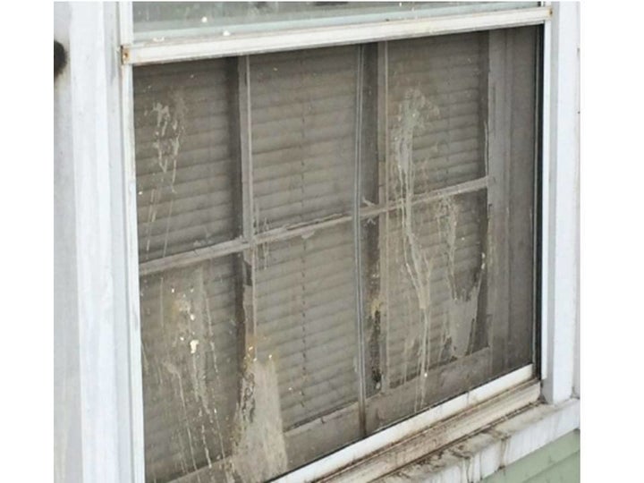 A close-up of a damaged window at the home of Albert Clemens Sr.