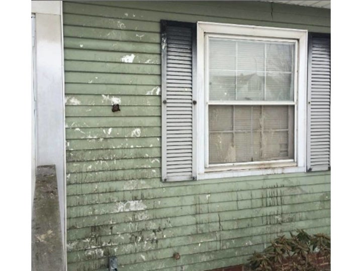 A view of Clemens' home, covered in debris from repeated vandalism.