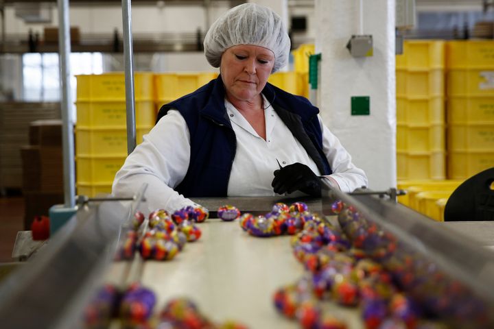 An employee monitors foil-wrapped Cadbury Creme Eggs as they move along the production line at the Bournville Cadbury factory in Birmingham (File photo)