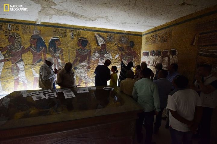 Antiquities Minister Mamdouh Eldamaty, Egyptologist Nicholas Reeves and others examine the walls of King Tut's tomb, looking for signs of a hidden passage in an image provided by National Geographic.
