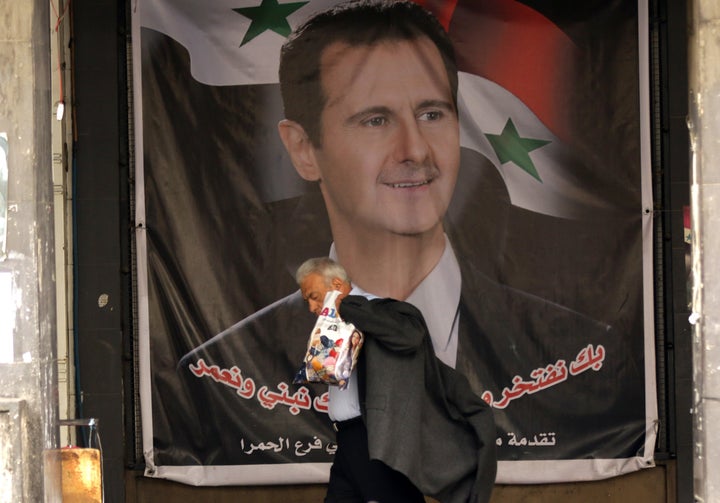 A poster of Bashar Assad in Damascus. Assad's regime cultivated and facilitated many of the jihadist forces that he now fights against, Lister says.