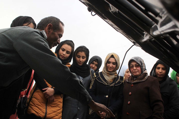 Instructors teach women taking a driving class how car engines work in Sheberghan, Afghanistan, on Jan. 20, 2016.