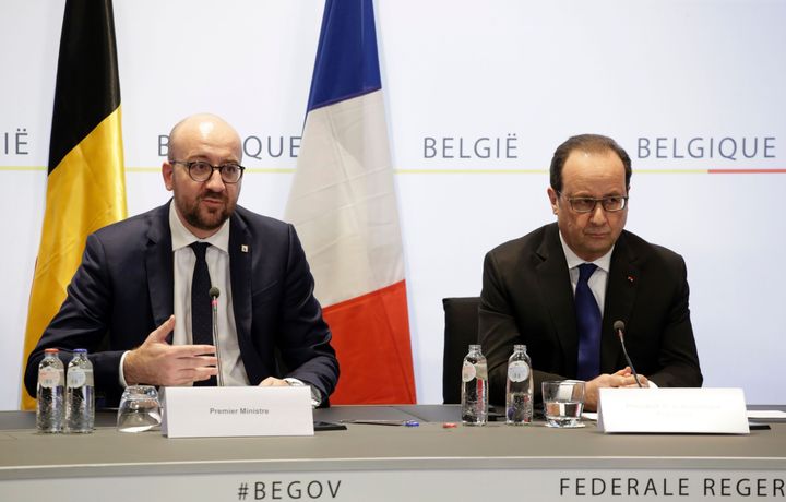 Michel (left) and Hollande (right) address reporters