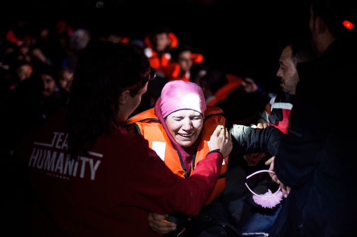 A Syrian refugee cries shortly after arriving on an inflatable boat with other refugees, crossing the sea from Turkey to Lesbos on March 12, 2016 in Mytelene, Greece