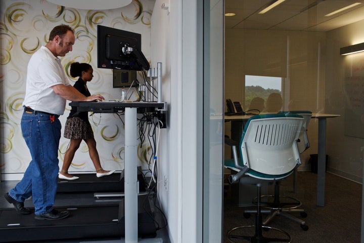 Workers use treadmill desks in Arlington, Virginia. 