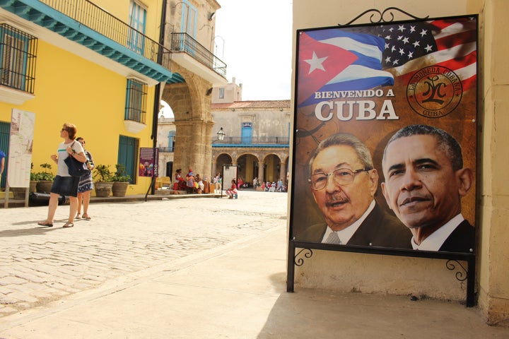 A sign in heavily touristed Old Havana, where Obama will take a walking tour on Sunday, shows him alongside Cuban head of sta