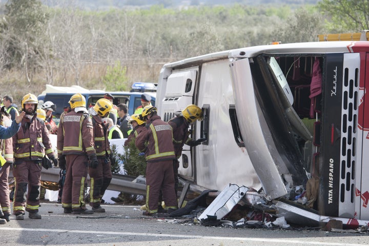 Officials inspect the destroyed vehicle 