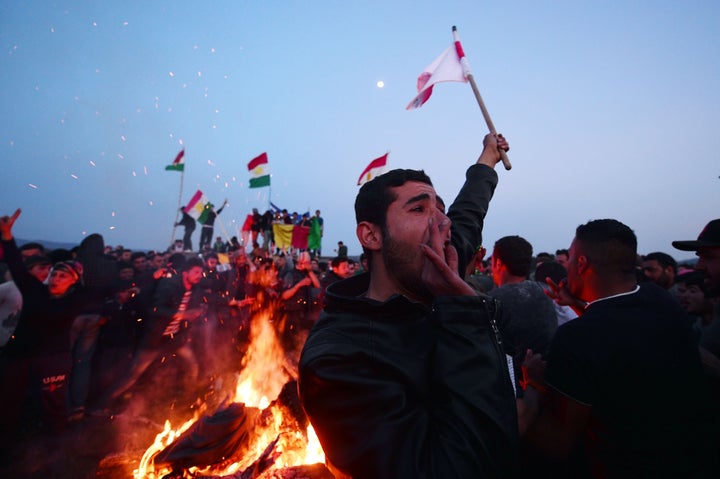 Kurdish Syrians chanted and danced around a large bonfire in Idomeni, Greece, on Sunday to celebrate the beginning of Nowruz,