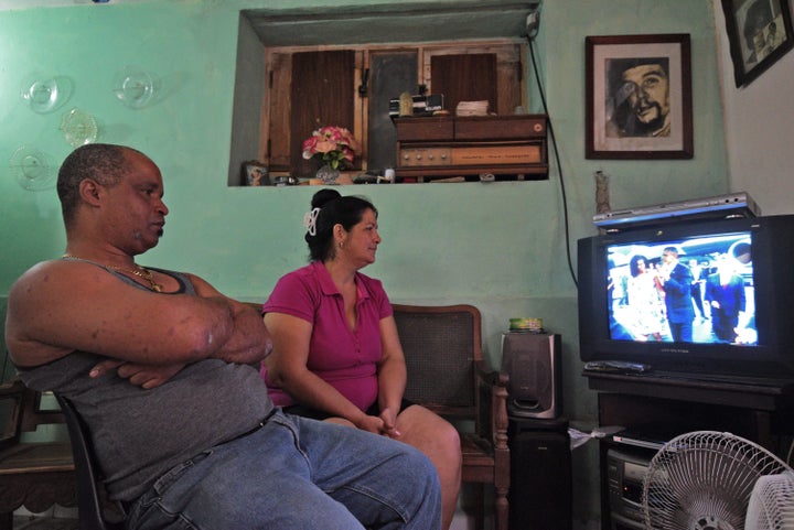 A family in Havana watches President Barack Obama arrive in Cuba on March 20, 2016.