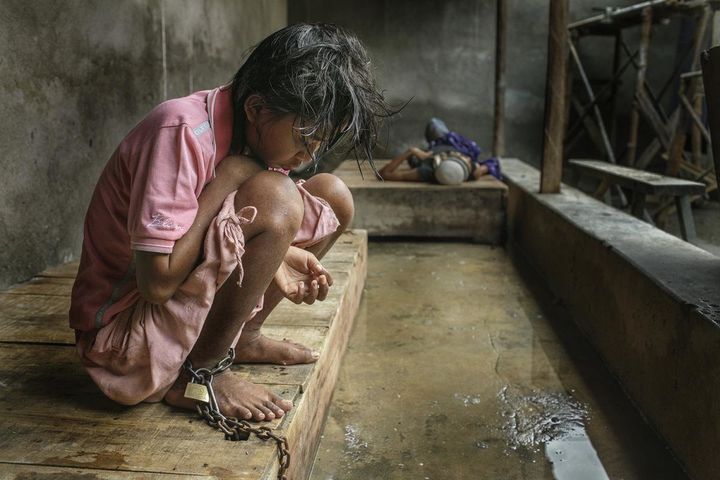 Before she died, this woman lived chained at Bina Lestari healing center in Brebes, Central Java for over two years. Her family paid for her platform bed and for the Islamic-based healing she received at the center.