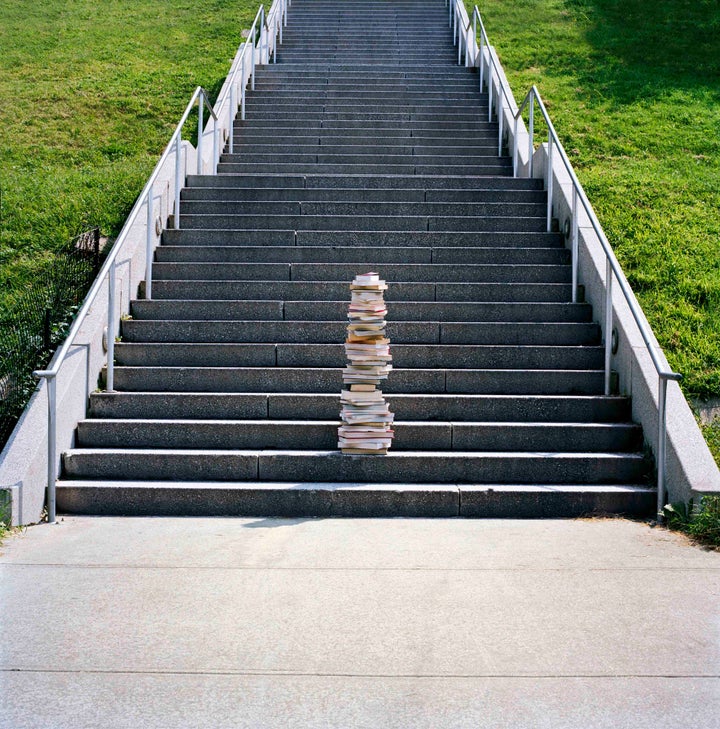 Stack of books left in on steps near the Hudson River.