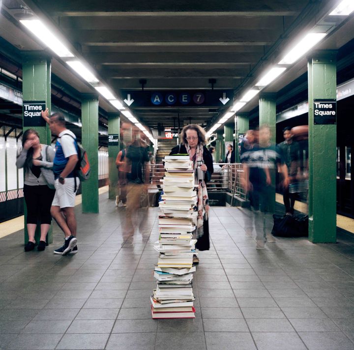 Stack of books left on a Times Square subway platform.