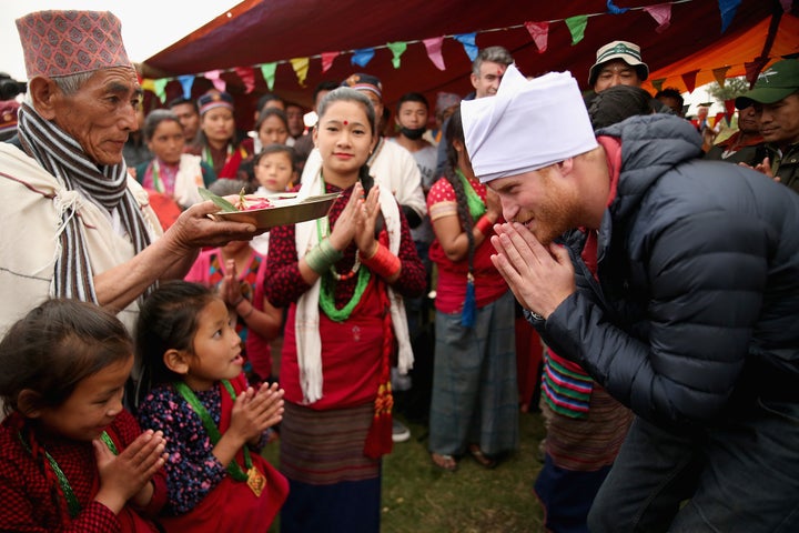 Prince Harry dons his pheta turban after being given the honour of being 'village head man' in Leurani, Nepal.