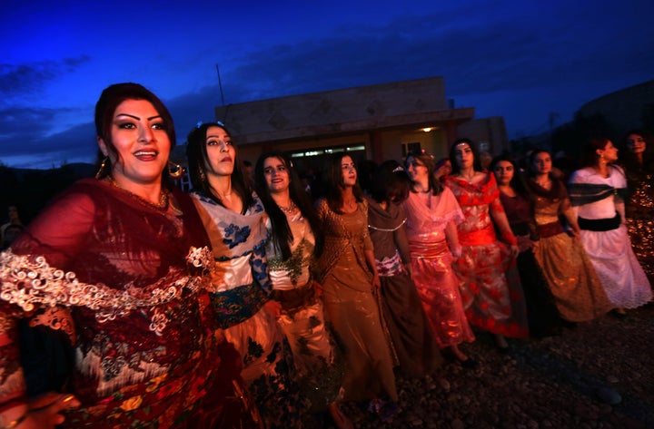 Iranian Kurdish women perform a traditional dance as they celebrate Noruz, the Persian New Year, in the town of Koya, 100 kms north of Arbil, the capital of the autonomous Kurdish region of northern Iraq, on March 19, 2016.