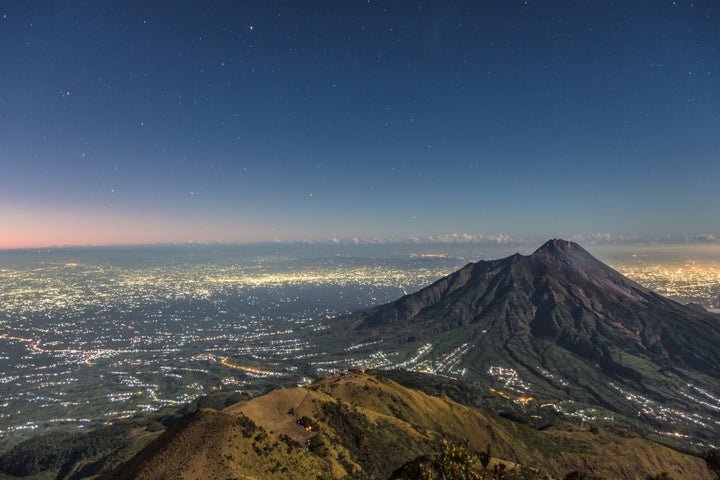 Mount Merapi, a highly active volcano, towers over the city.