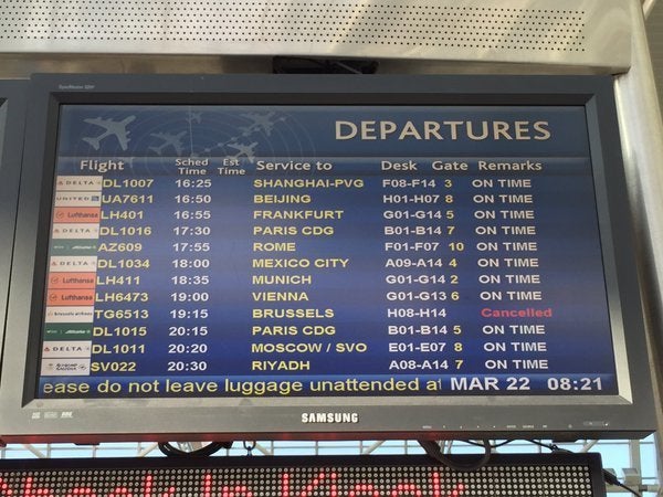 A list of departures at New York's JFK Airport shows a Brussels-bound flight canceled.