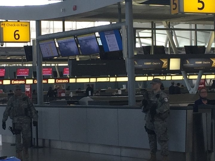 Armed guards are seen patrolling a check-in gate at JFK airport on March, 22, 2016.