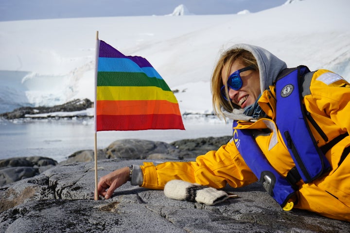 A Planting Peace member plants a flag in Antarctica.