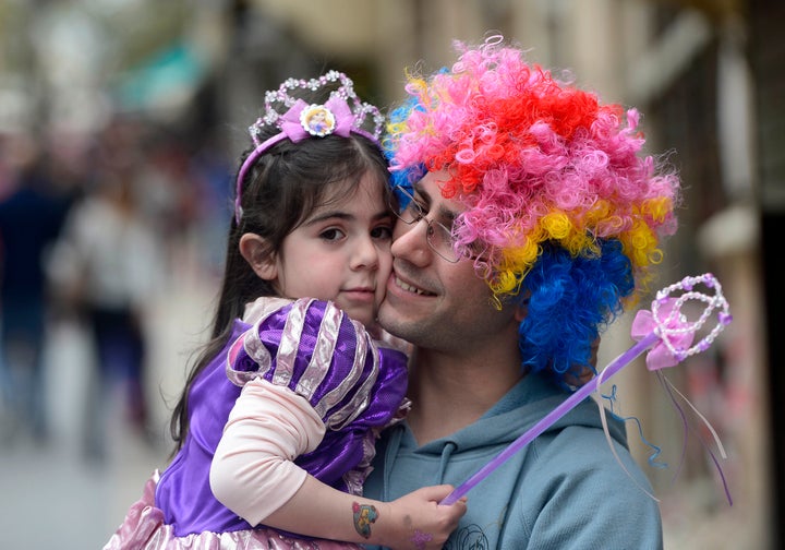 People dressed in costumes celebrate the Jewish holiday of Purim in Jerusalem on March 17, 2014.