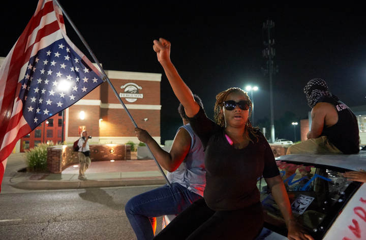 A protester holds their first in the air outside of the Ferguson Police Department in Missouri.