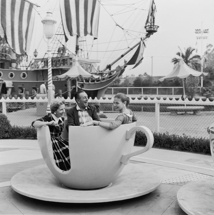 Lillian Disney and her husband, Walt Disney, take one of Disneyland's spinning tea cups for a ride with their daughter, Diane.