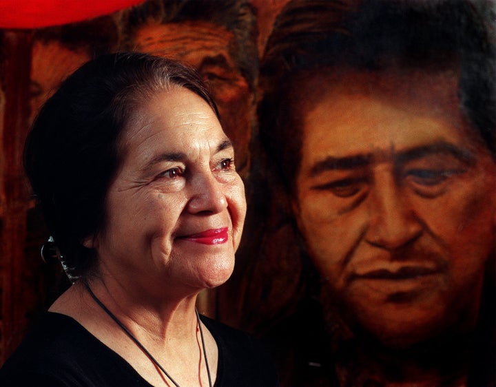 Dolores Huerta appears before a painting of her dear friend, Cesar Chavez.