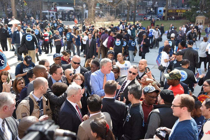 New York City Mayor Bill de Blasio, surrounded by union and AARP supporters, urged City Council to pass zoning laws aime