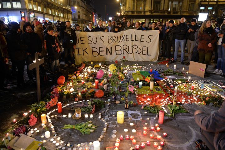 Belgian people light candles as they gather to commemorate victims of terror attack at the Place de la Bourse in Brussels, Belgium on March 22, 2016