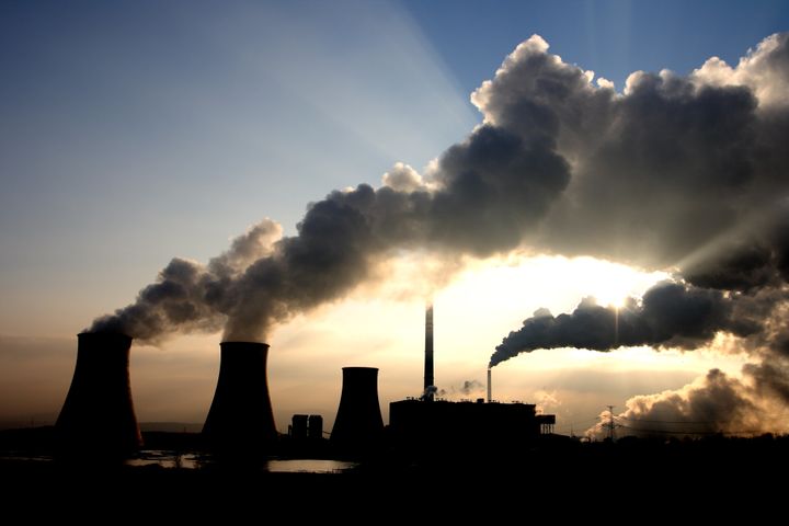 Steam rises from the cooling towers of a coal-fired power plant. Burning coal is one of the human activities that are linked to carbon emissions. Current carbon emissions from humans reached a record high of about 37 billion metric tons in 2014, a new study shows.
