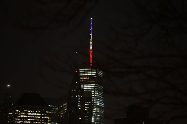 The spire of One World Trade Center is lit Tuesday night as a sign of solidarity with Belgium following attacks there. W