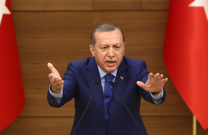 Turkish President Recep Tayyip Erdogan gestures as he delivers a speech during the local town government heads meeting at the Presidential Complex in Ankara on March 16, 2016
