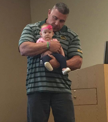 The professor, holding Millie during lecture.