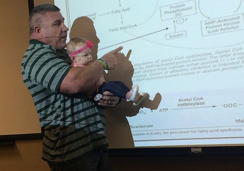 Prof. Darryn Willoughby holding baby Millie.