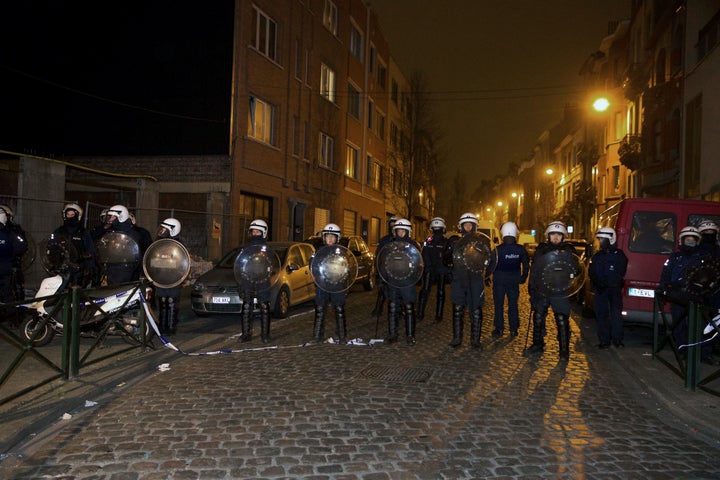 Policemen stand guard the street at Rue de la Carpe in Molenbeek-Saint-Jean in Brussels, on March 19, 2016. 