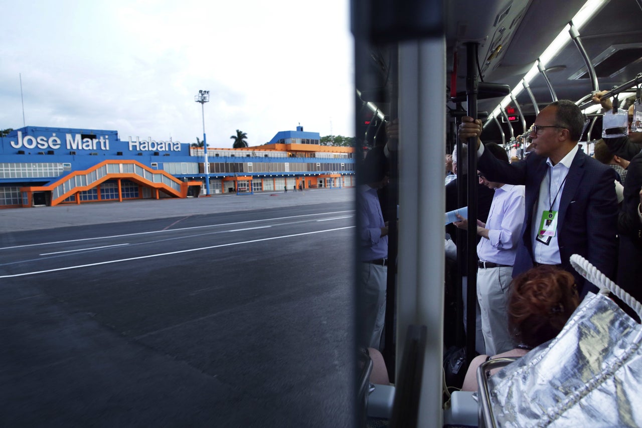 Journalists, including NBC news anchor Lester Holt, ride in a bus at José Martí International Airport upon their arrival in Cuba.