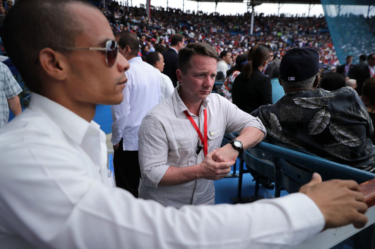 A Cuban security agent works with a member of the U.S. Secret Service at Havana's Estadio Latinoamericano, where Castro and Obama watched a baseball game together.