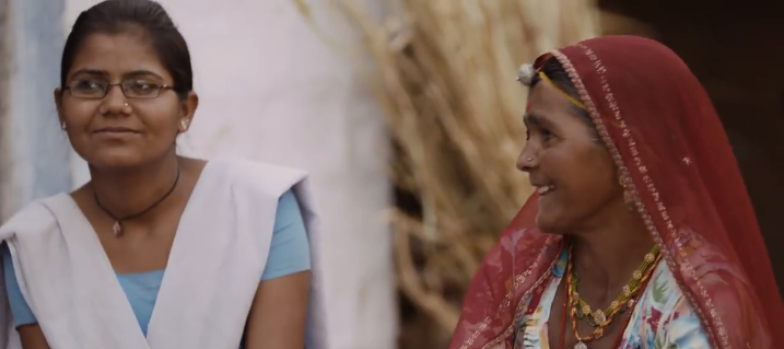 In the video, Pramilla sits with her mother, who never went to school. 