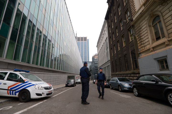 A picture taken in Brussels on March 19, 2016, shows the Belgian police officers standing outside the Belgian Federal Police headquarters.
