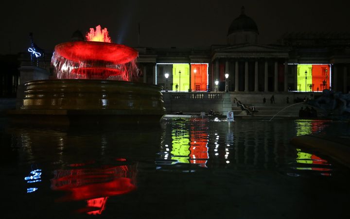Belgian national flags are projected on to the facade of The National Gallery in central London on March 23, 2016