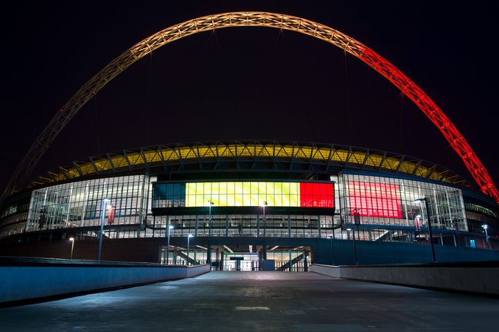 The arches of Wembley Stadium are illuminated with the colours of the flag of Belgium on March 23, 2016 in London, England